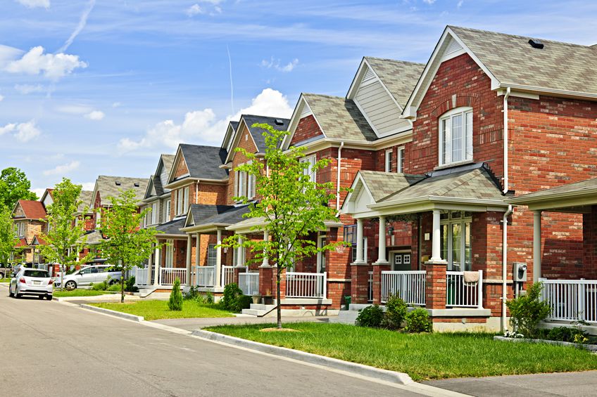 suburban residential street with red brick houses