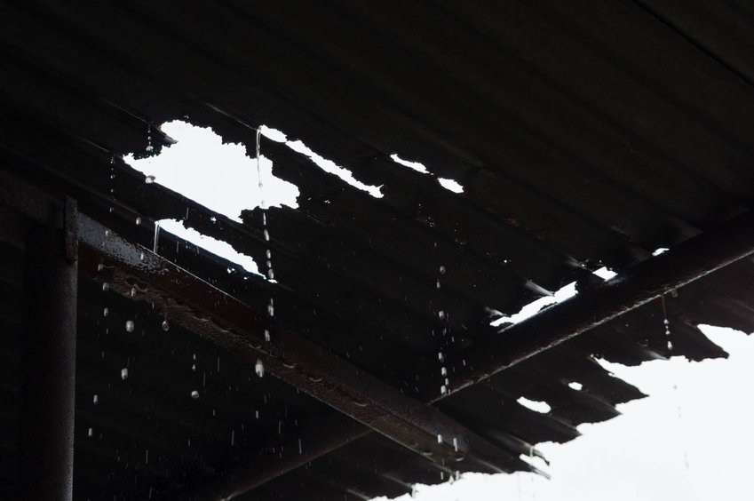 Rain pouring through a leaky tin roof